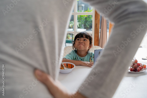 Картината върху платно portrait of a mother get angry with stubborn kid using mobile phone
