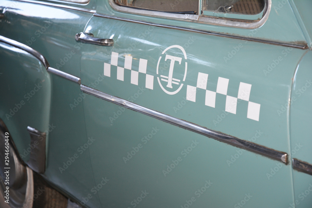 Close up on USSR 1950s taxi car with taxi sign.  Taxi cab concept