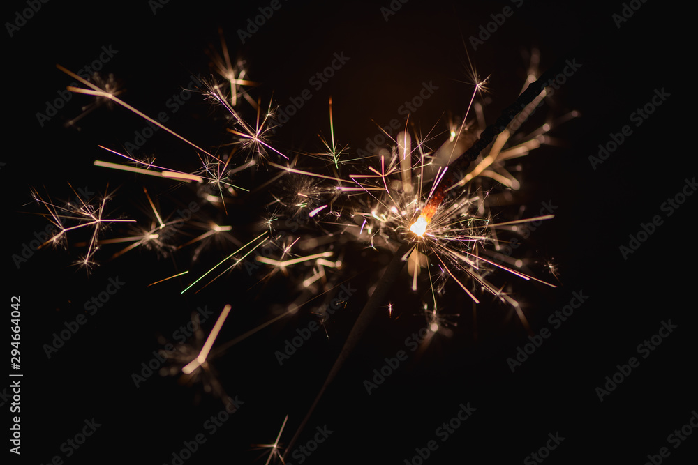 Burning sparklers on a dark background