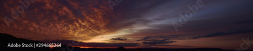 Evening, summer sunset. Panoramic photo, late afternoon, alarming, red sunset.