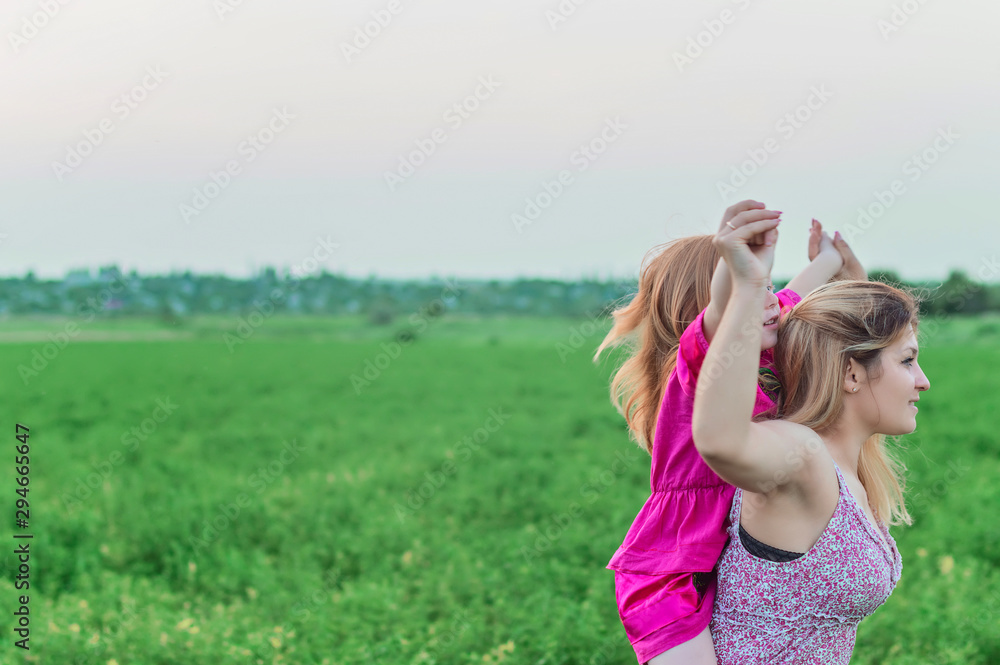Mother holds her daughter in her arms. Concept of friendship and trust Mother holds her daughter in her arms. Concept of friendship and trust