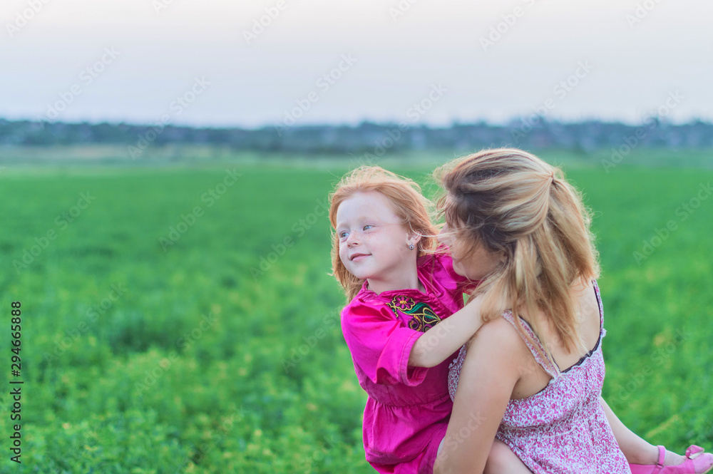 Happy mother with her daughter in a field Happy mother with her daughter in a field