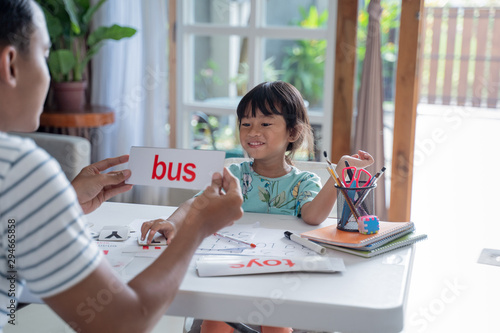 Cuadro en lienzo happy kid learning and studying together with parent at home
