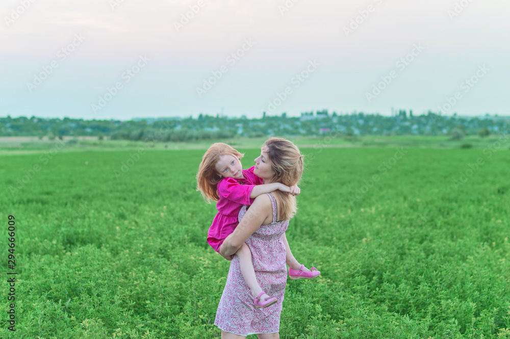 Happy mother with her daughter in a field Happy mother with her daughter in a field