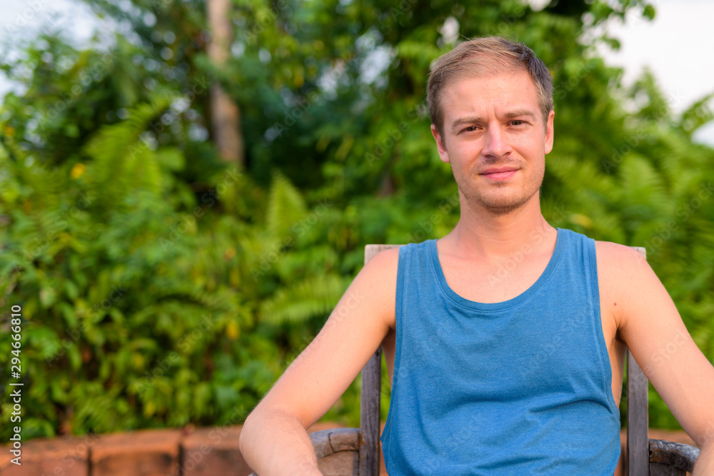 Young handsome man with blond hair relaxing outdoors Young handsome man with blond hair relaxing outdoors