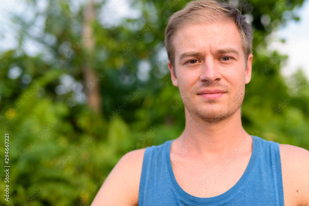 Young handsome man with blond hair relaxing outdoors Young handsome man with blond hair relaxing outdoors