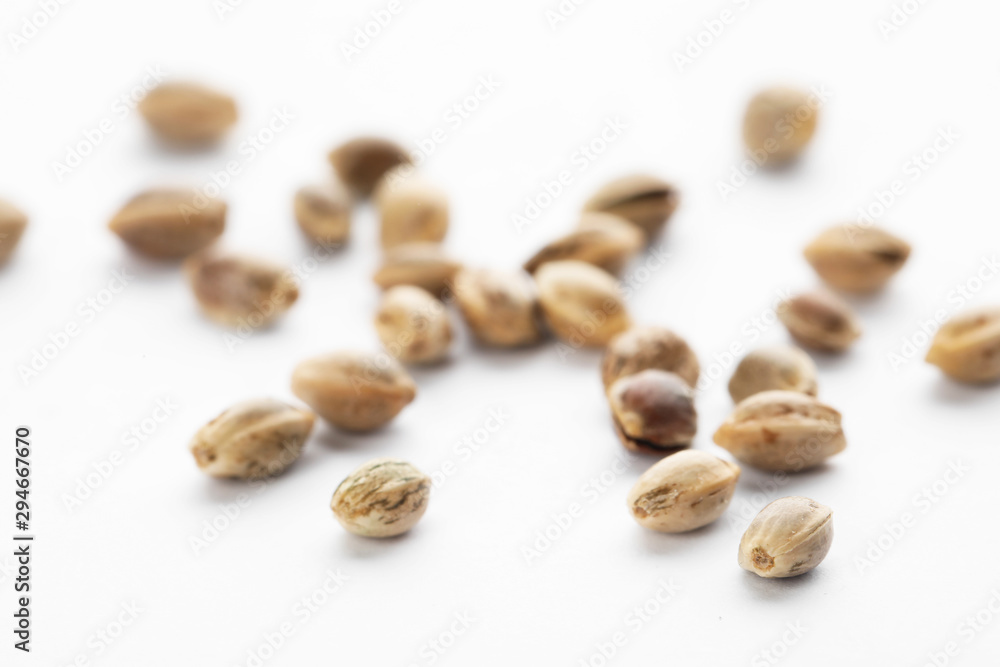 Raw organic hemp seeds on white background Raw organic hemp seeds on white background