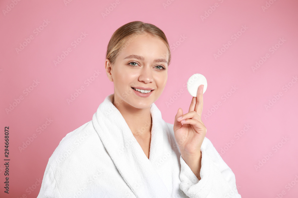 Beautiful young woman with cotton pad on pink background Beautiful young woman with cotton pad on pink background