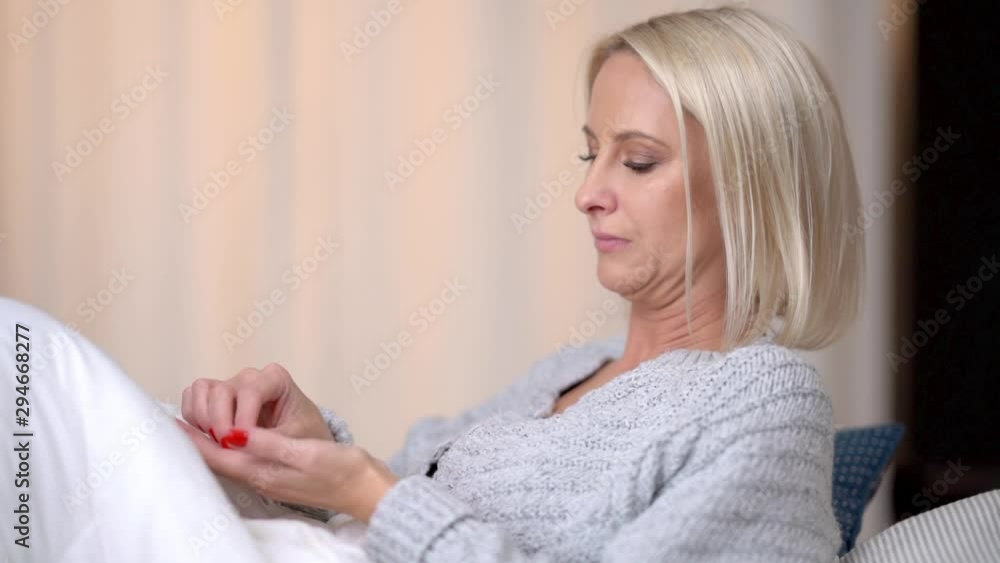 Adult sick woman taking medicine at home Adult sick woman taking medicine at home