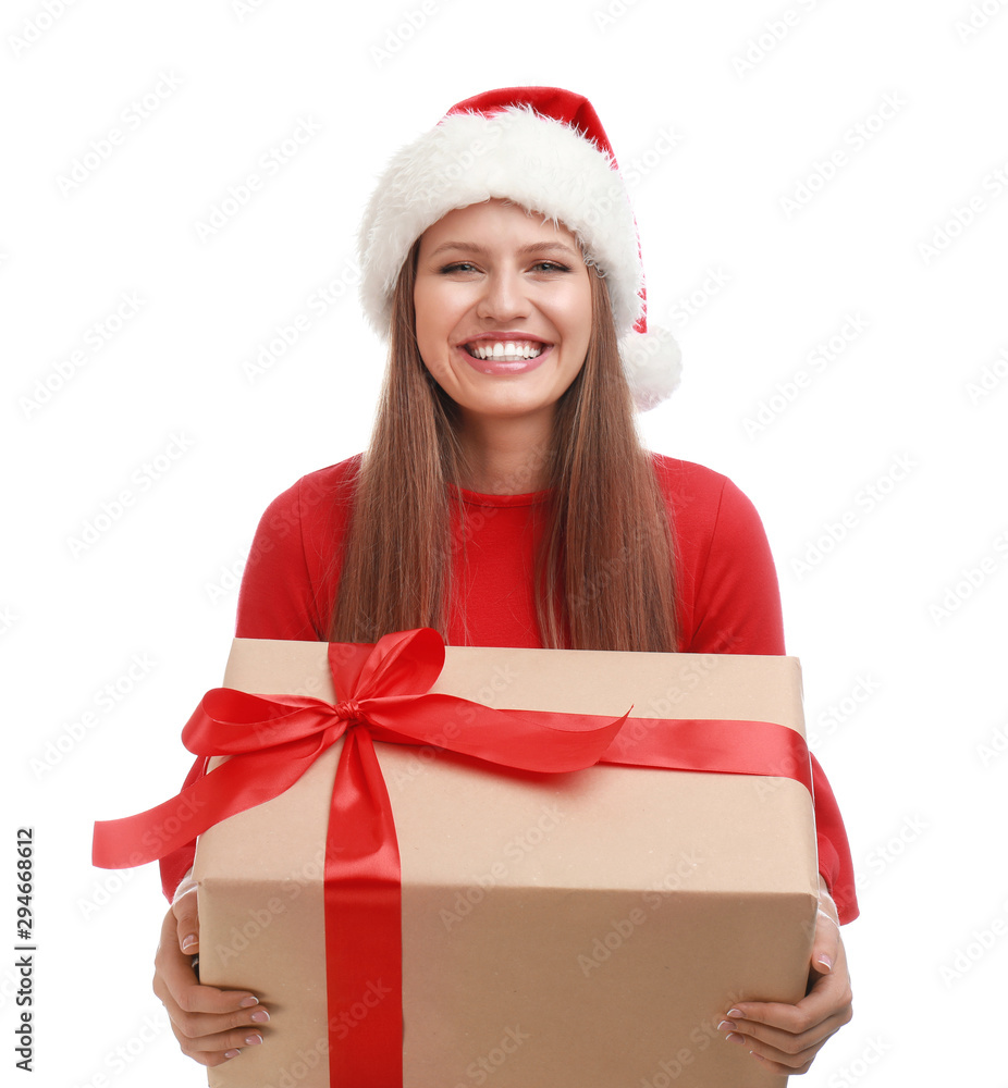 Happy young woman in Santa hat with Christmas gift on white background Happy young woman in Santa hat with Christmas gift on white background