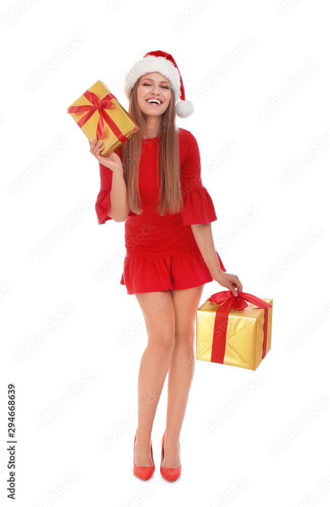 Happy young woman in Santa hat with Christmas gifts on white background Happy young woman in Santa hat with Christmas gifts on white background