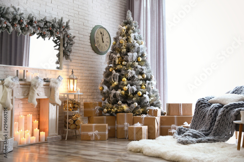 Stylish interior of living room with decorated Christmas tree photo