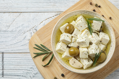Konstfotografi Flat lay composition with pickled feta cheese in bowl on white wooden table