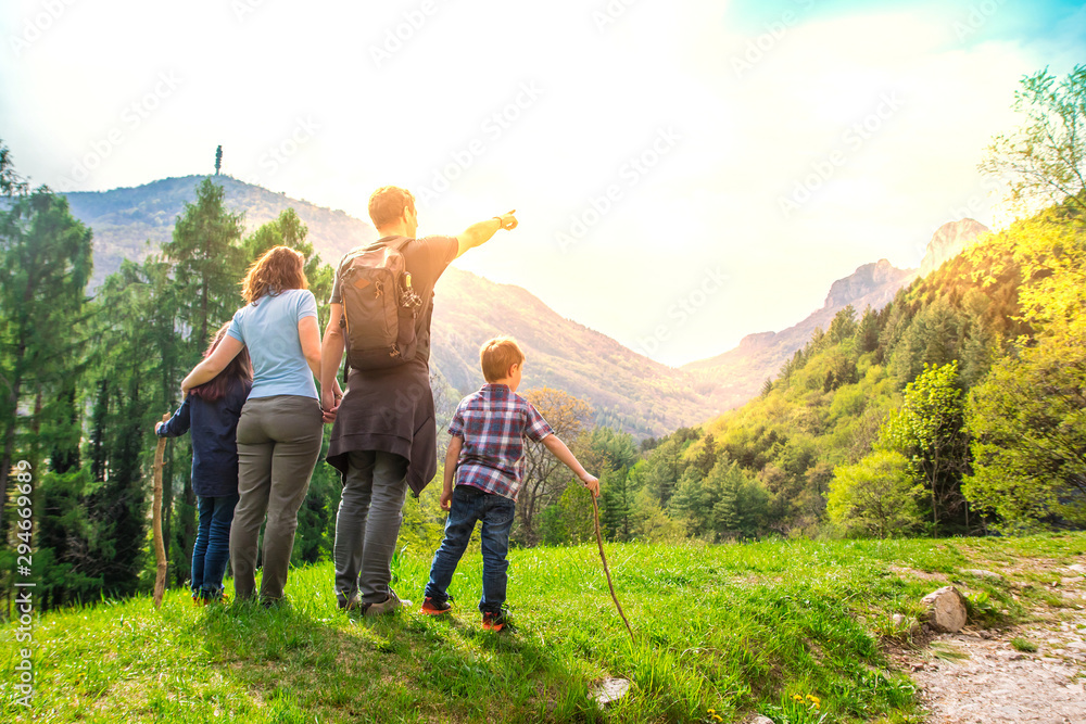 beautiful family is looking the landscape during a trekking