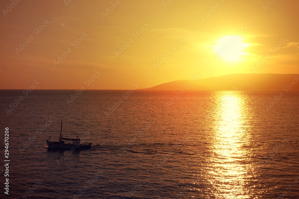 Photo of beautiful cloudy sunset with golden colours over the Aegean sea