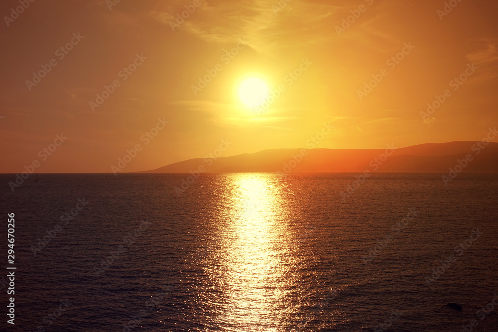 Photo of beautiful cloudy sunset with golden colours over the Aegean sea