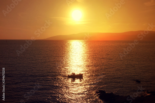 Photo of beautiful cloudy sunset with golden colours over the Aegean sea