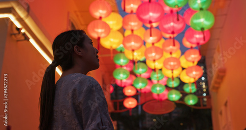 Woman look at the chinese traditional lantern hanging at outdoor in the evening