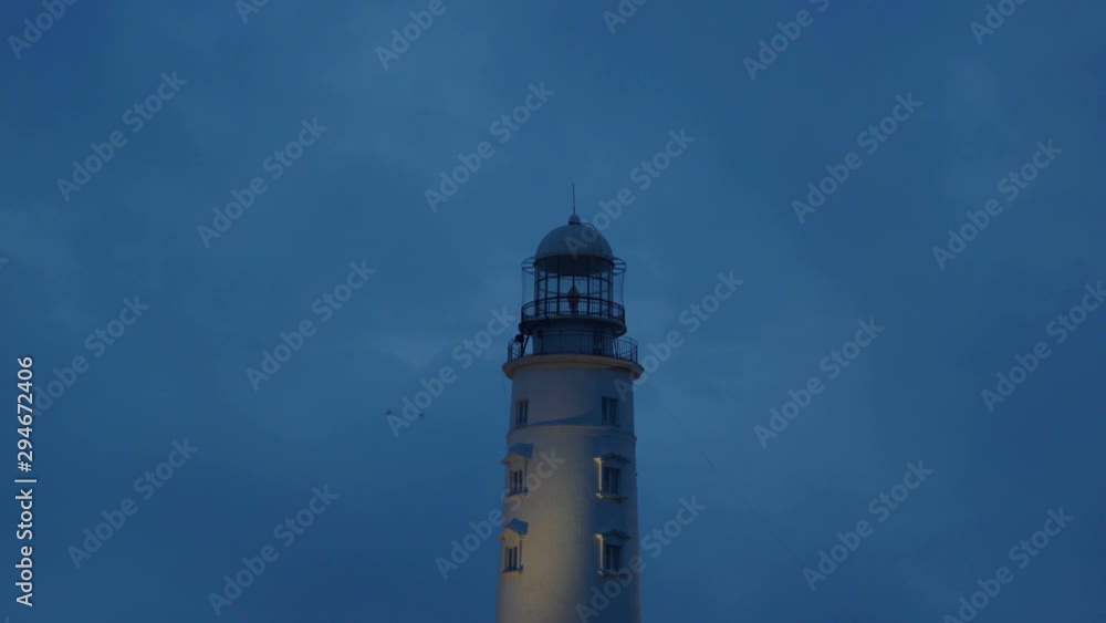 Picturesque white lighthouse at the dusk time. 4k footage. Picturesque white lighthouse at the dusk time. 4k footage.
