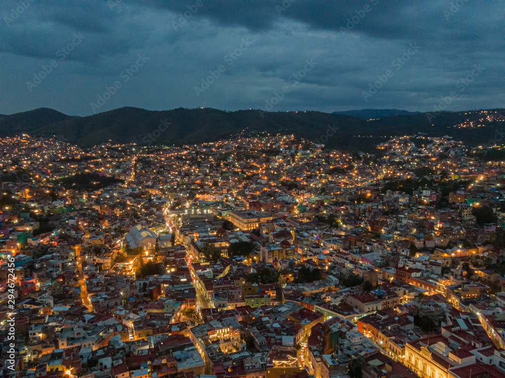 Panoramic photo in the night of Guanajuato City, México, colorful city and alleys.