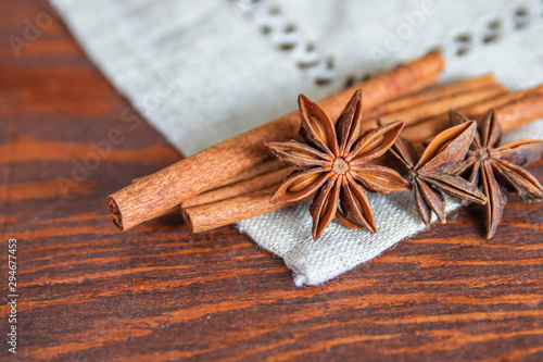Star anise and cinnamon sticks on wooden background