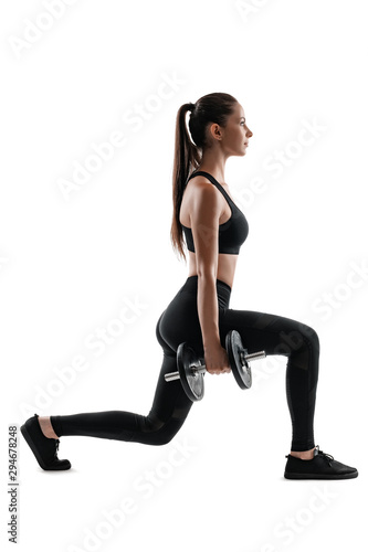 Brunette woman in black leggings, top and sneakers is posing isolated on white. Fitness, gym, healthy lifestyle concept. Full length.
