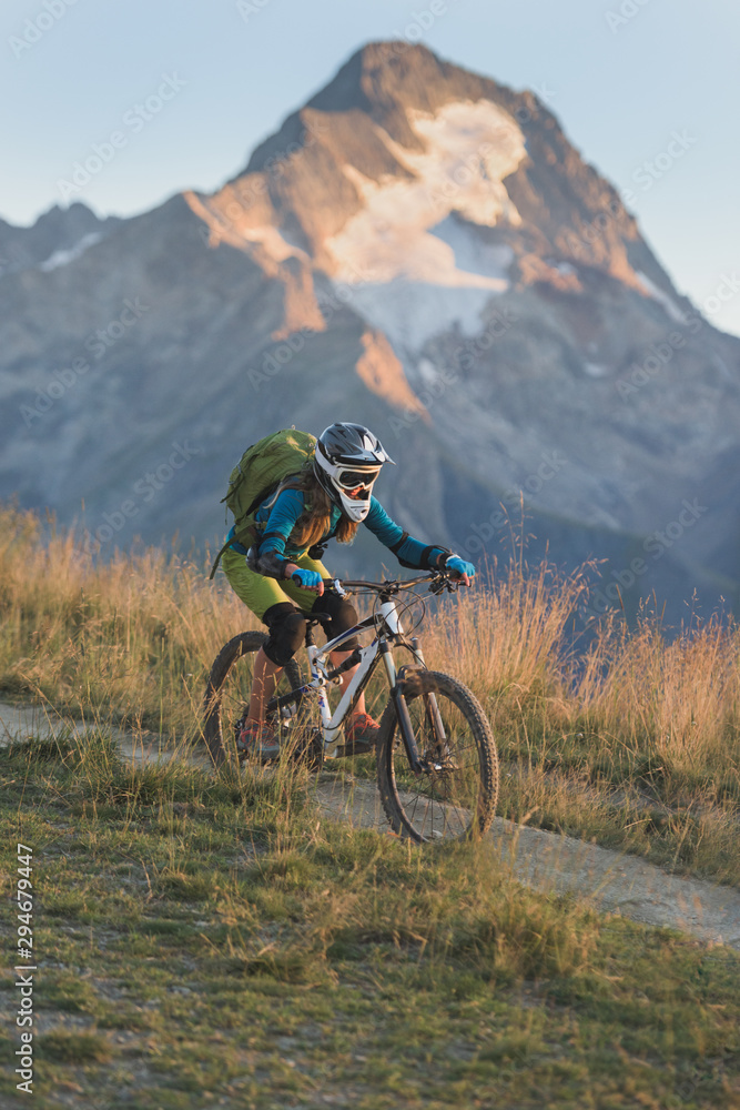 Portrait of woman riding mountain bike in the French Alps Portrait of woman riding mountain bike in the French Alps