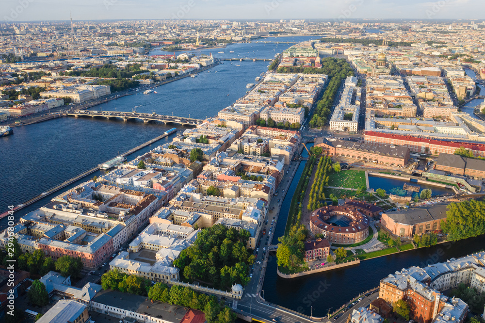Aerial drone view of historical city, modern park between two artificial river channel, round building in the center, new Holland, Saint Petersburg, Russia