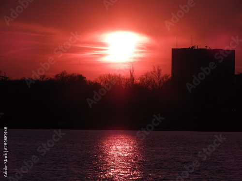 Red sunset with silhouette of trees, Beautiful zoom in shot of the sun at dawn
