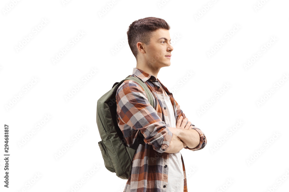 Young guy with a backpack standing with arms crossed Young guy with a backpack standing with arms crossed