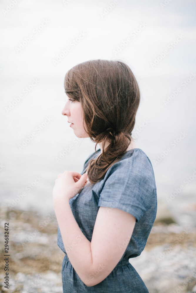Woman standing by the ocean Woman standing by the ocean
