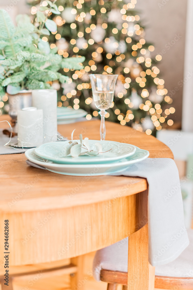 Christmas wooden table, a glass of champagne, table setting