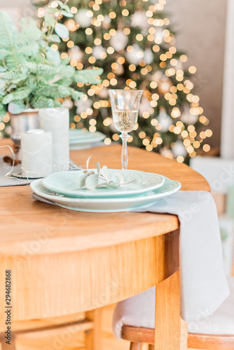 Christmas wooden table, a glass of champagne, table setting