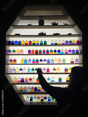 A young woman chooses color during Aura Soma session