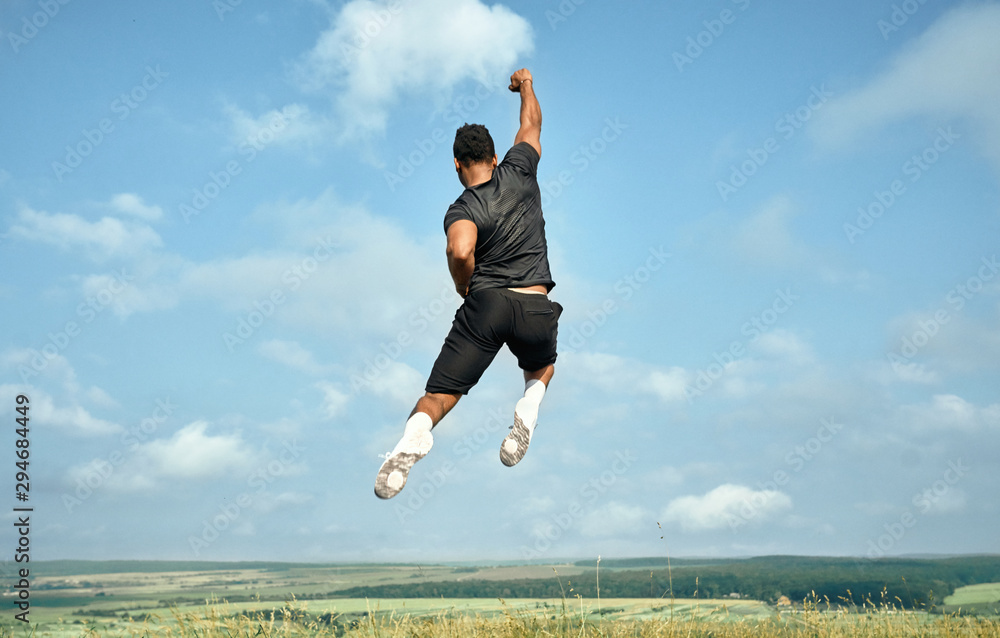 Athlete jumping high on background of blue sky. Athlete jumping high on background of blue sky.
