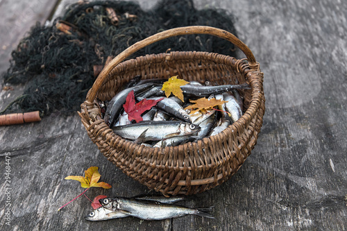 Fresh fish in a basket on a boardwalk gray background
