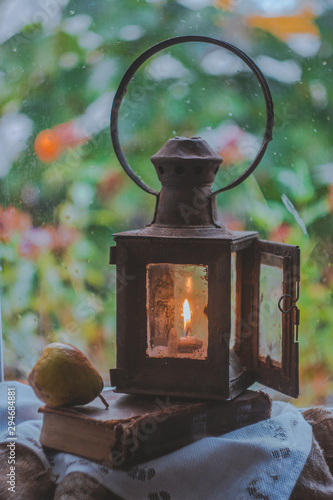 Rainy day outside the window. Still life with vintage lamp
