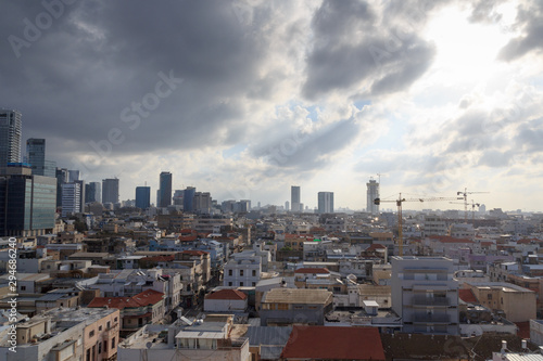 Skyline panorama of city Tel Aviv with some dark storm clouds and urban skyscrapers in the morning, Israel