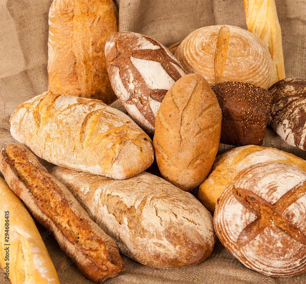 Several types of bread on burlap background