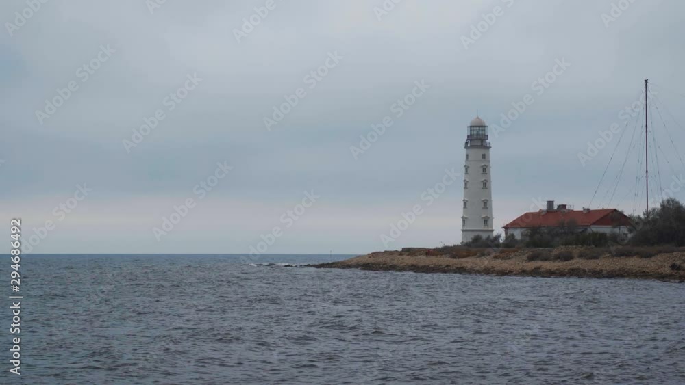 Picturesque white lighthouse at the dusk time. 4k footage. Picturesque white lighthouse at the dusk time. 4k footage.