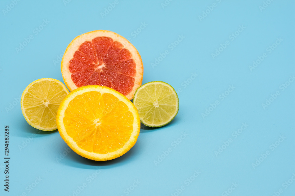 various citrus slices of orange lime lemon and grapefruit arranged on colorful background abstract wallpaper with copy space various citrus slices of orange lime lemon and grapefruit arranged on colorful background abstract wallpaper with copy space
