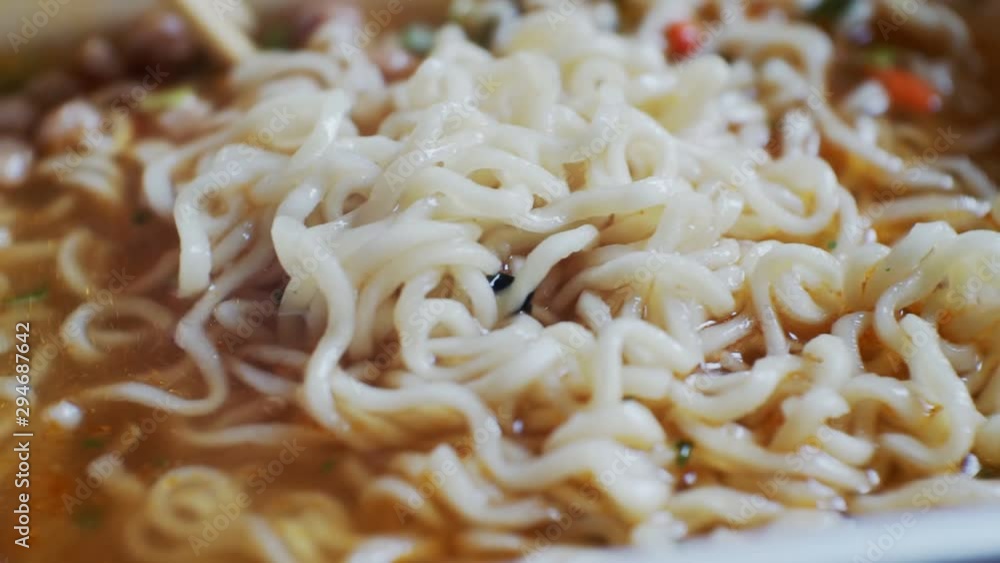 unhealthy diet.fast food.instant noodles in a bowl of broth.close-up. unhealthy diet.fast food.instant noodles in a bowl of broth.close-up.