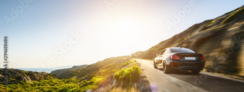 Vászonkép rental car in spain mountain landscape road at sunset