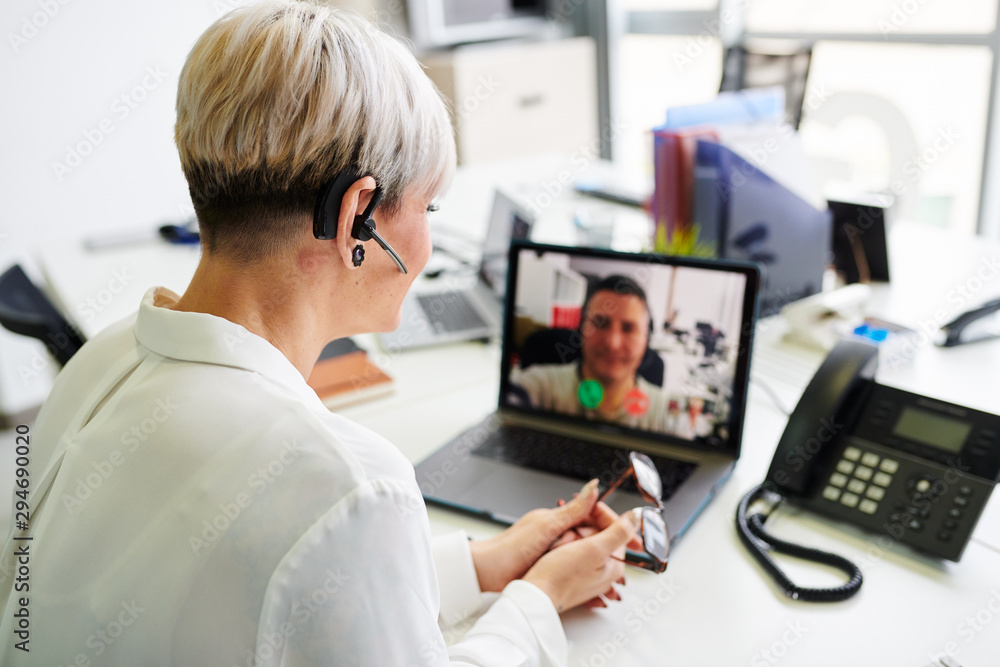 Woman having video call at table Woman having video call at table