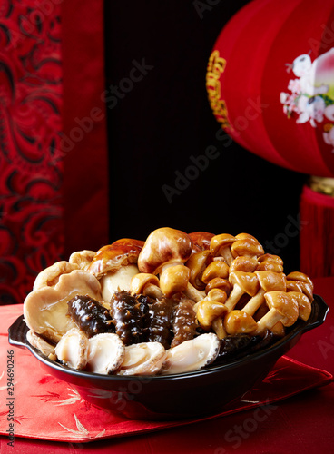 Chinese traditional food Miscellaneous sea cucumber abalone, on the table in a festive New Year atmosphere photo