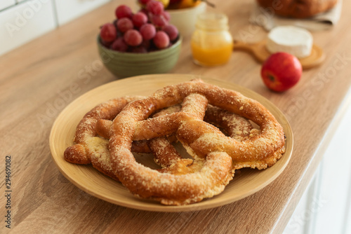 Pretzels, grape and honey on the kitchen table, breakfast