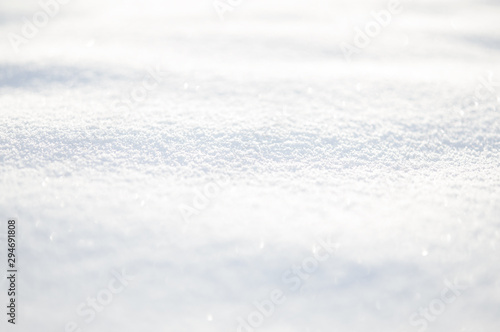 White snow wavy surface close up and flakes background