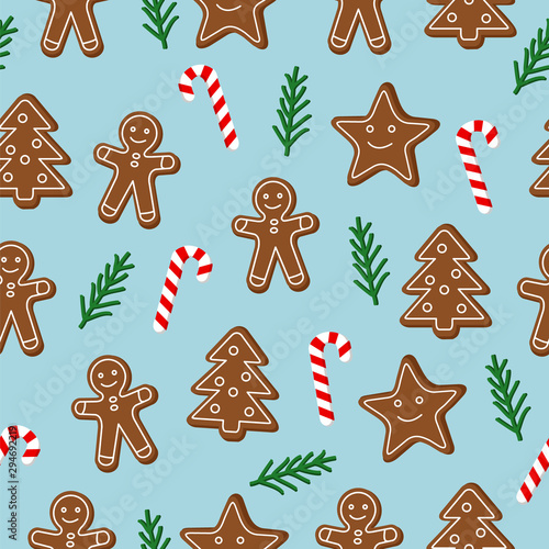 Christmas seamless pattern. Brown gingerbread cookies with lolipop candy cane and green spruce tree twig on blue background. Graphic design element for wrapping paper, prints, scrapbooking, simple