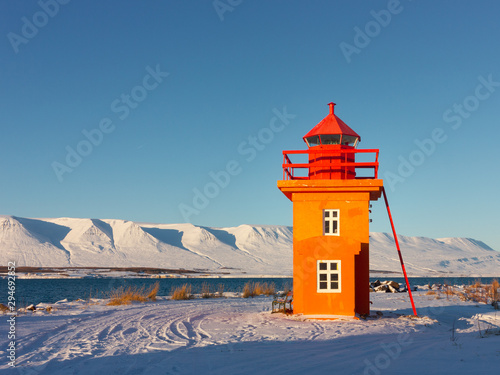 Bild auf Leinwand Orange lighthouse near the city of Akureyri in northern Iceland