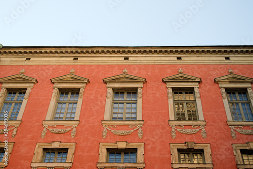 Red vintage building with windows. Copy space